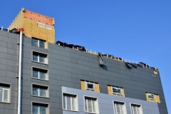 Facing of the building ventilated facade. Aluminum colored facades. Modern facades of high-rise buildings. Construction of a large shopping business center.